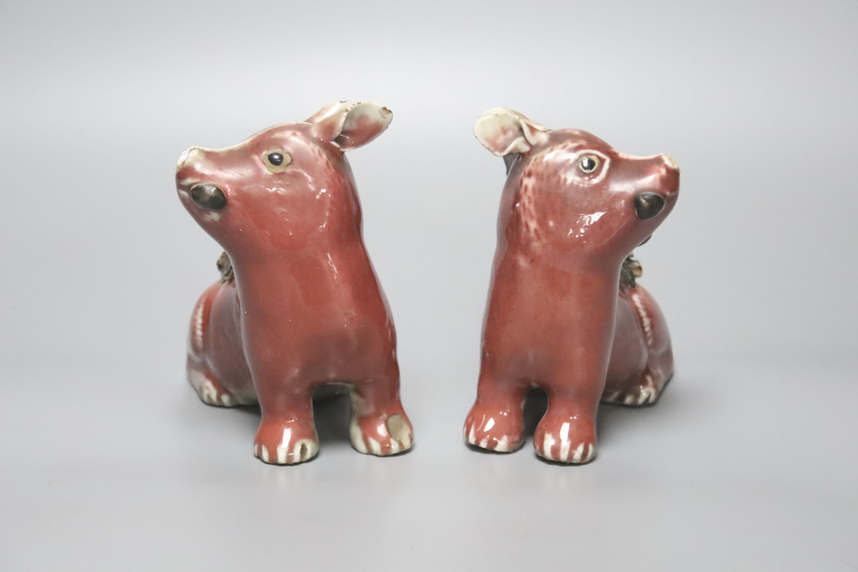 A pair of unusual Chinese copper red glazed pig incense burners/ joss stick holders, late Qing dynasty, height 13cm